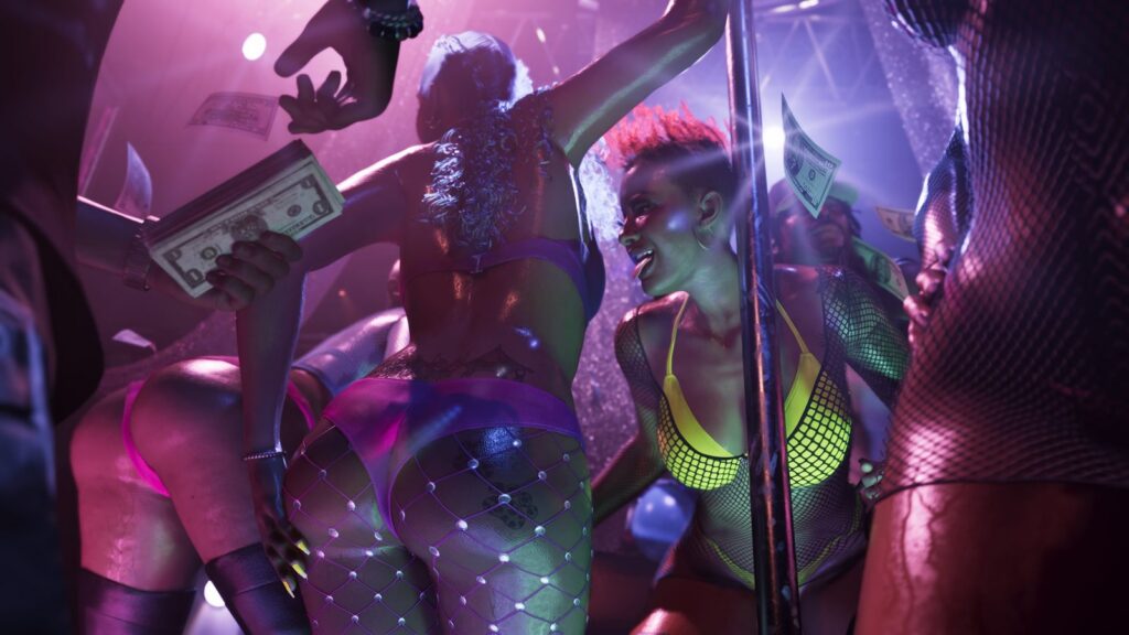 Dancers on a neon-lit stage in a Vice City club as a customer at the front holds up cash. Image: Rockstar Games.