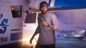 Jason stands with a pistol outside a marina trailer at dusk, a speedboat behind him. Image: Rockstar Games.