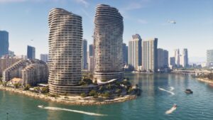 Two curved glass towers on the Vice City waterfront, boats on the water below. Image: Rockstar Games.