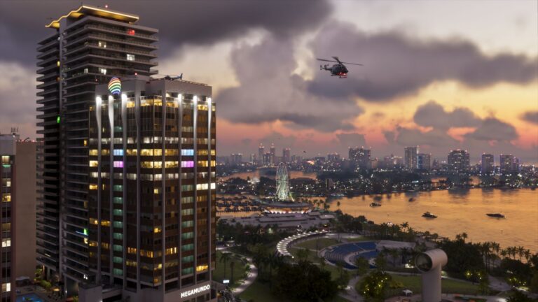 A Vice City tower block at dusk with the bay and marina beyond, a helicopter passing. Image: Rockstar Games.
